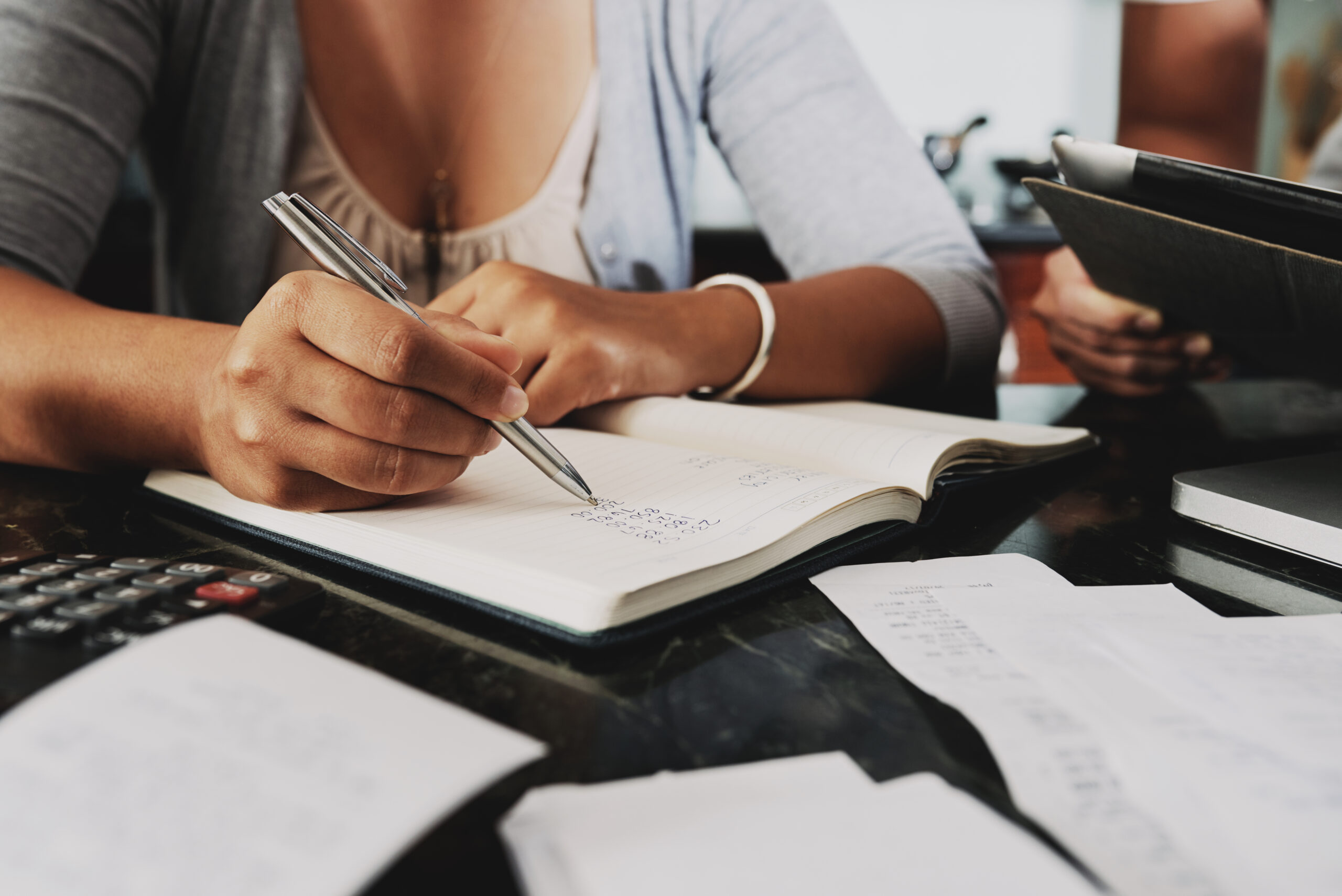 Cropped image of woman analyzing budget and counting income